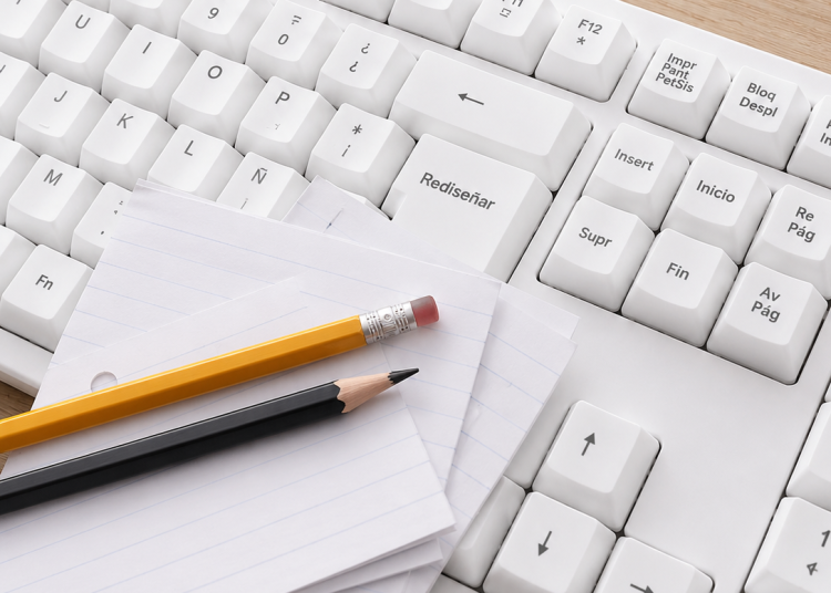 Teclado blanco con la tecla "Rediseñar" destacada, acompañado de hojas y lápices sobre el teclado, representando la reconstrucción institucional y el proceso de actualización de los estatutos de Fundación Equicentro en la Región del Maule.